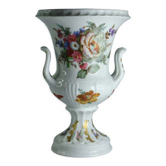 White porcelain vase with a bright bouquet of flowers from france.