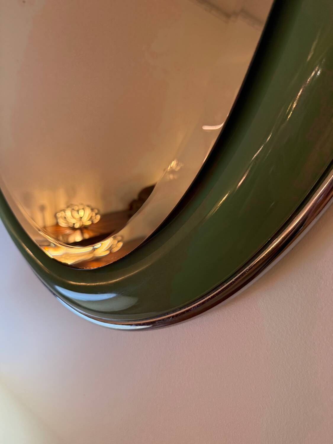 Vintage oval mirror with English green lacquered curved frame and chrome surround
