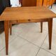 Old wooden desk or side table with compass legs