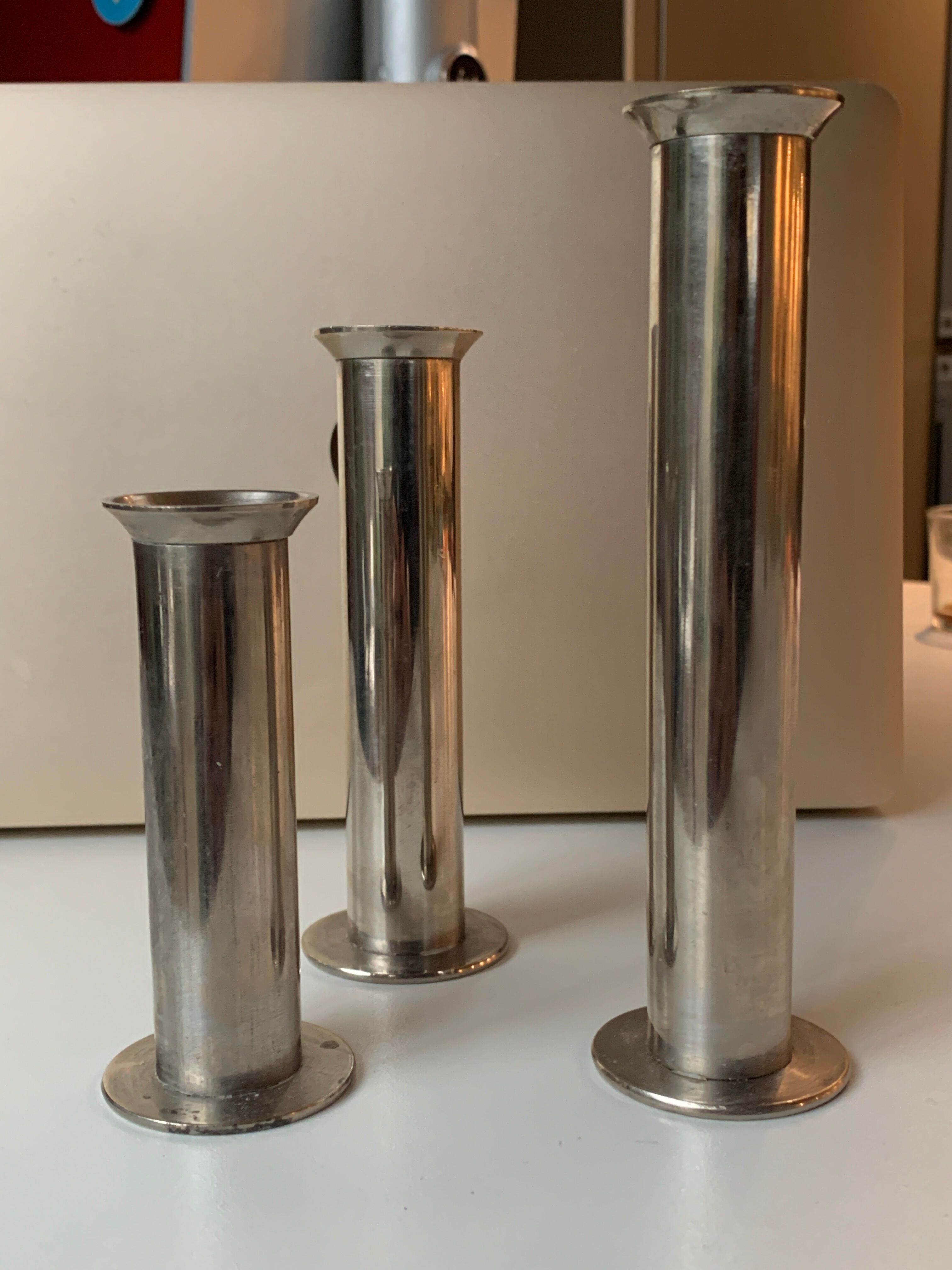 Three silver metal candle holders