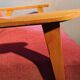Vintage red armchair with compass feet in Scandinavian design