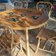 Round dining table Audoux Minet with 4 chairs and 2 armchairs.