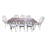 Ancienne table en fer forgé et ses fauteuils et chaises pour extérieur