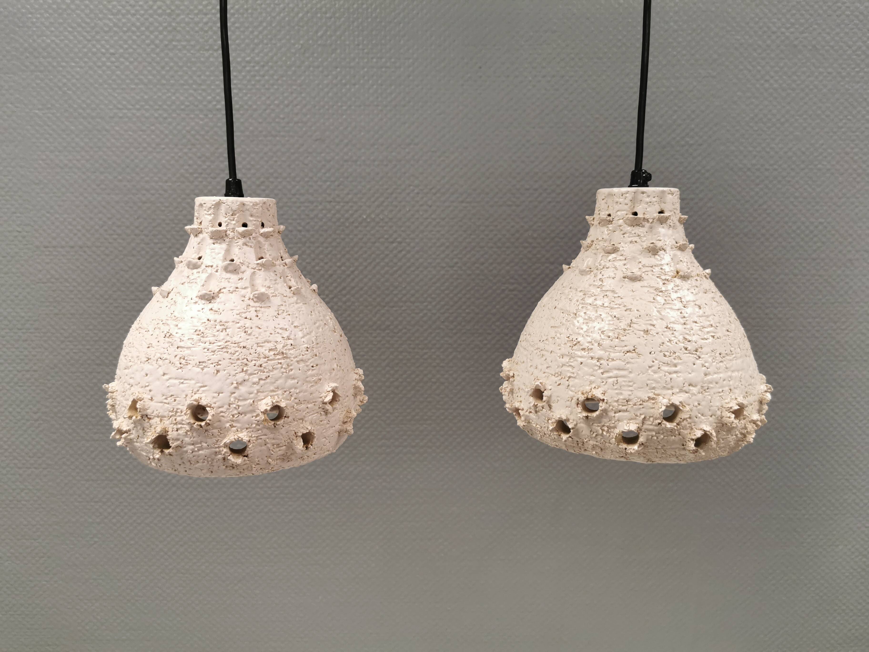 Two ceramic hanging lamps, in creamy white color, looking almost like coral