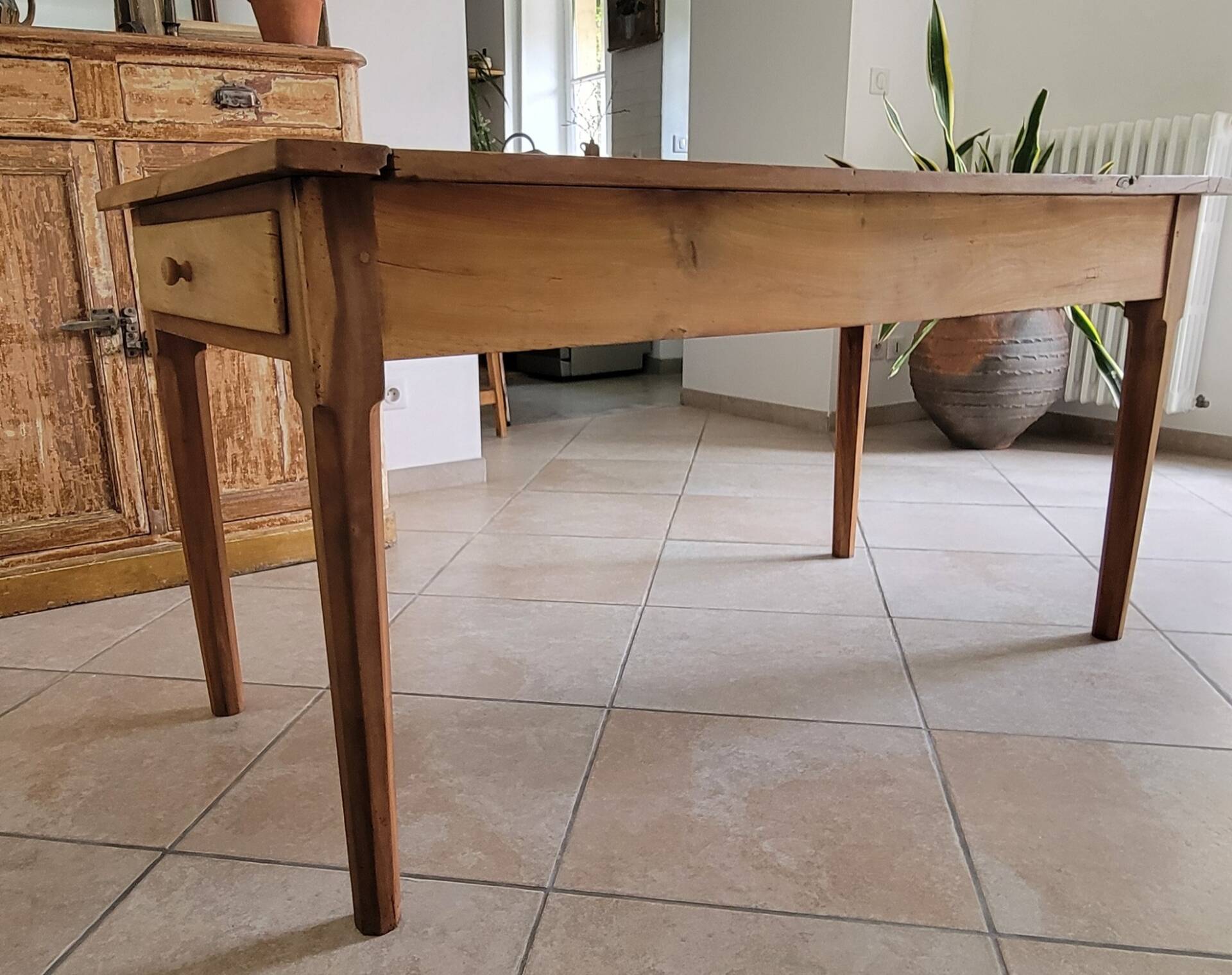 Old farmhouse table made of solid walnut wood.