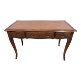 Louis XV style desk in wood, with a brown leather top.