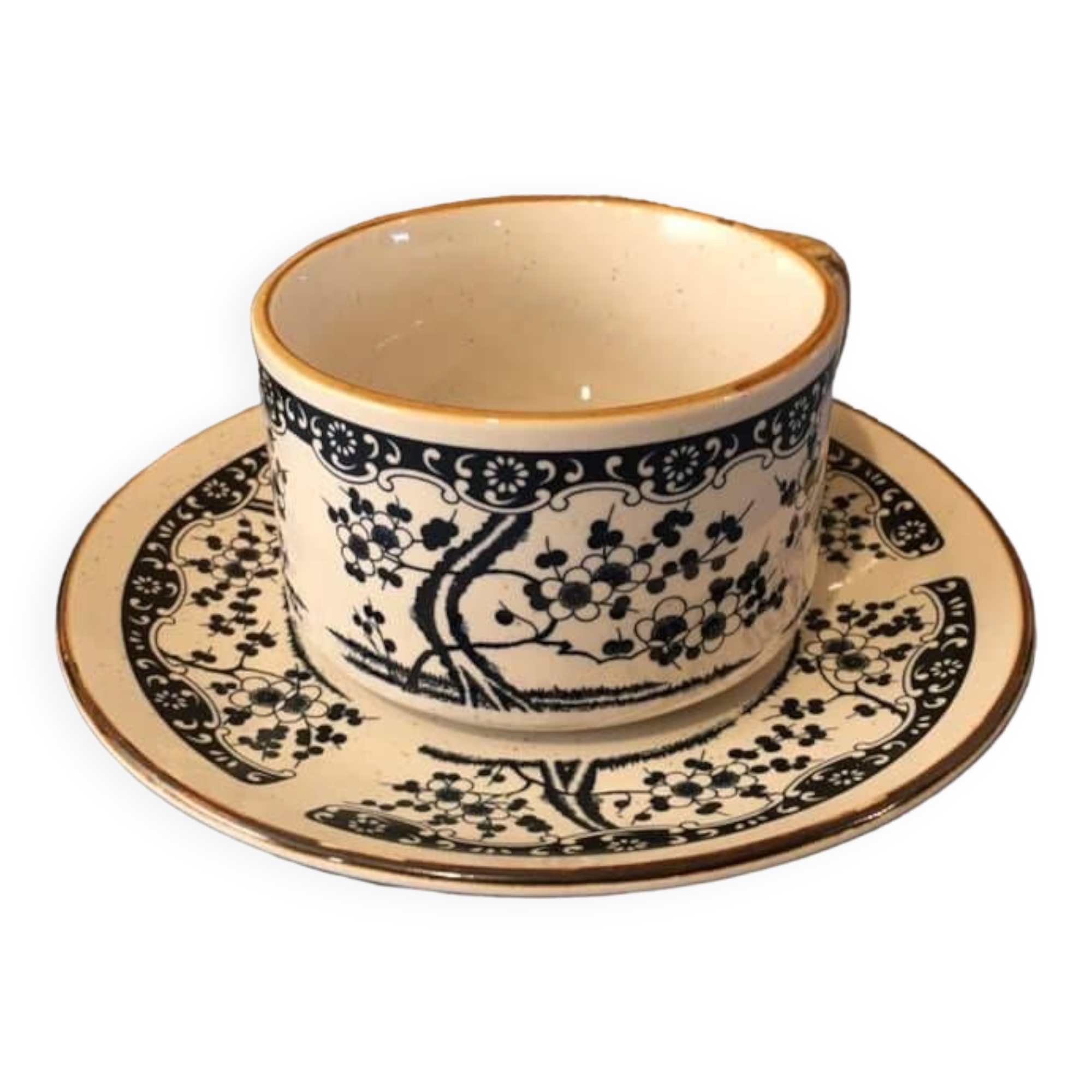 Large stoneware cup and saucer with delicate floral patterns