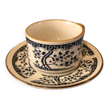 Large stoneware cup and saucer with delicate floral patterns