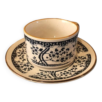 Large stoneware cup and saucer with delicate floral patterns