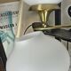Pair of vintage wall sconces in brass with white glass globe shades.