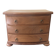 Blonde wooden doll's chest with brass handles.