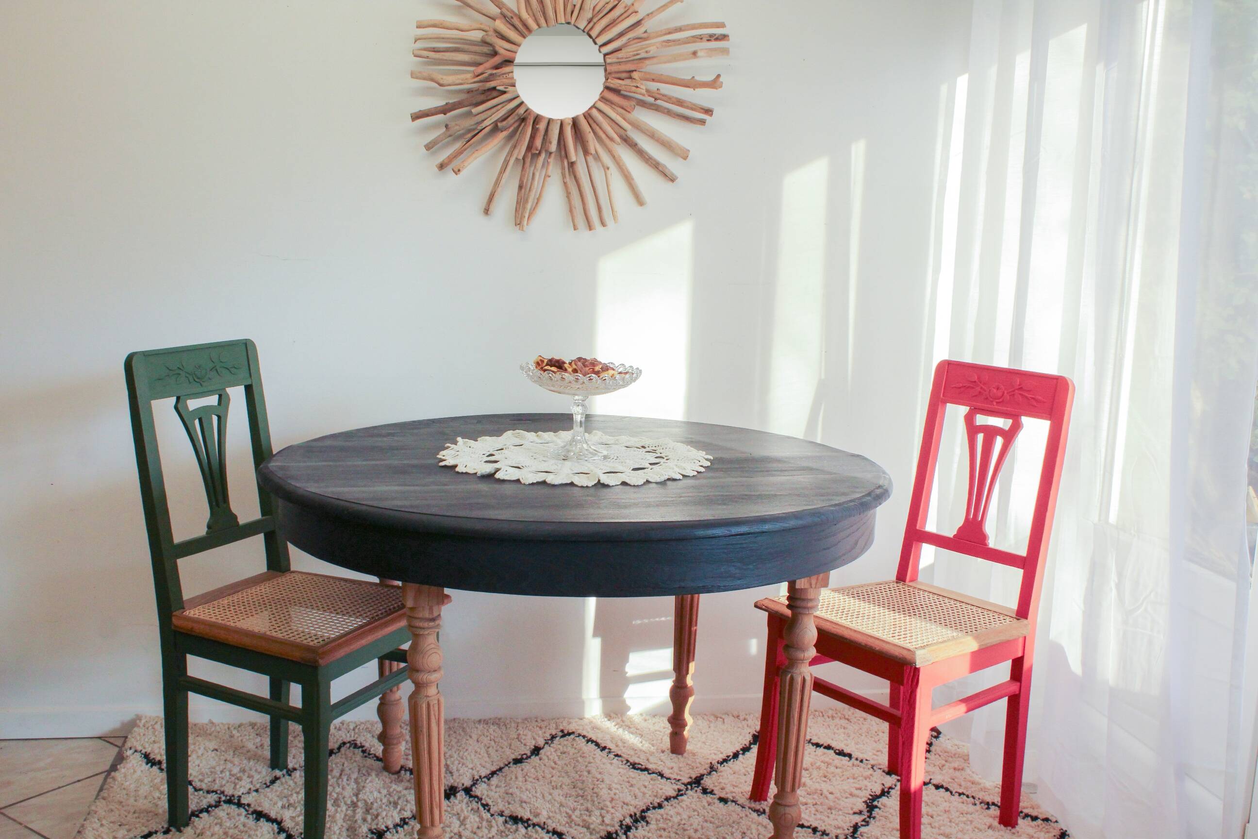Round black dining table with oak wood.