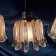 3 suspensions Doria en verre ambré, années 1960
