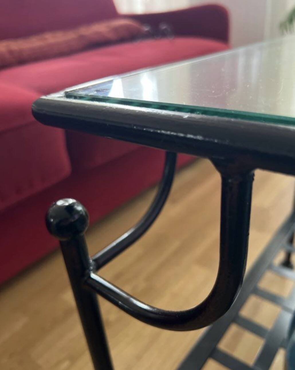 Coffee table with a glass top and black metal frame.