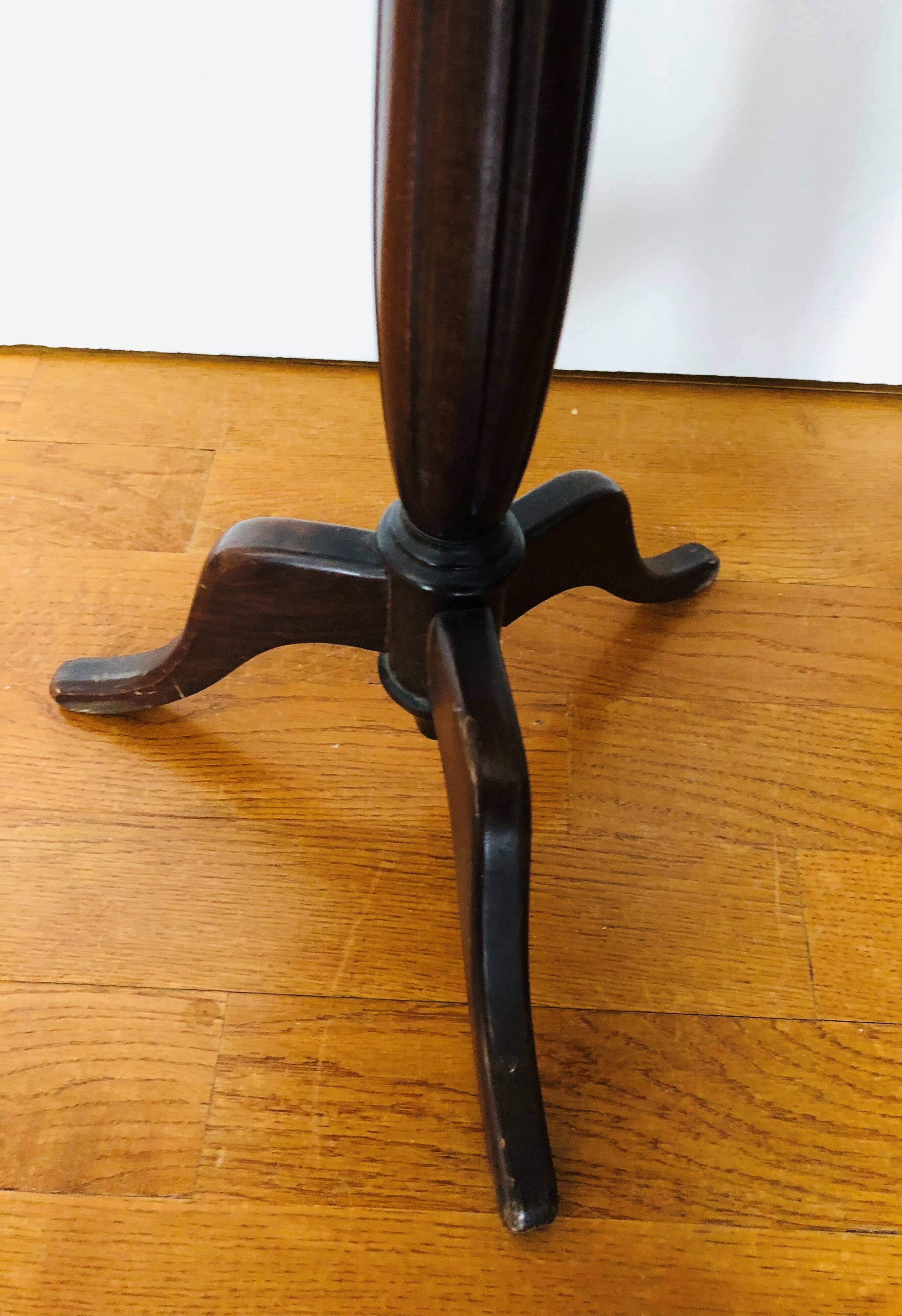 Wooden pedestal table on marble