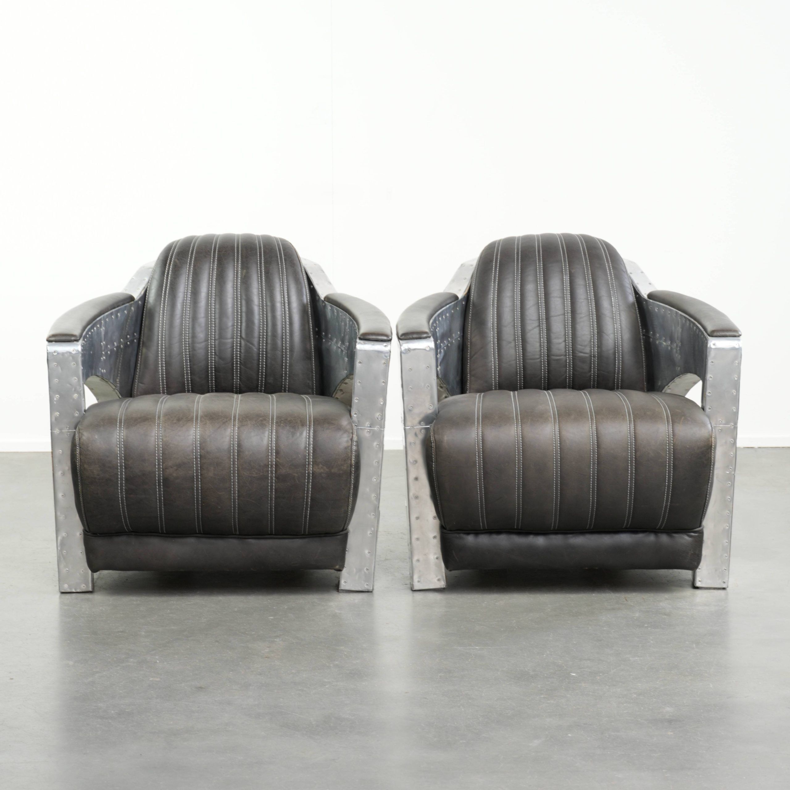 Set of 2 sturdy industrial black cowhide Aviator design armchairs with aluminium and rivets