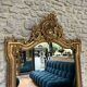 Antique mirror 169/105cm with pediments and pearl detailing in gold leaf.