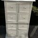 Small antique workshop cabinet with 8 painted wooden drawers.