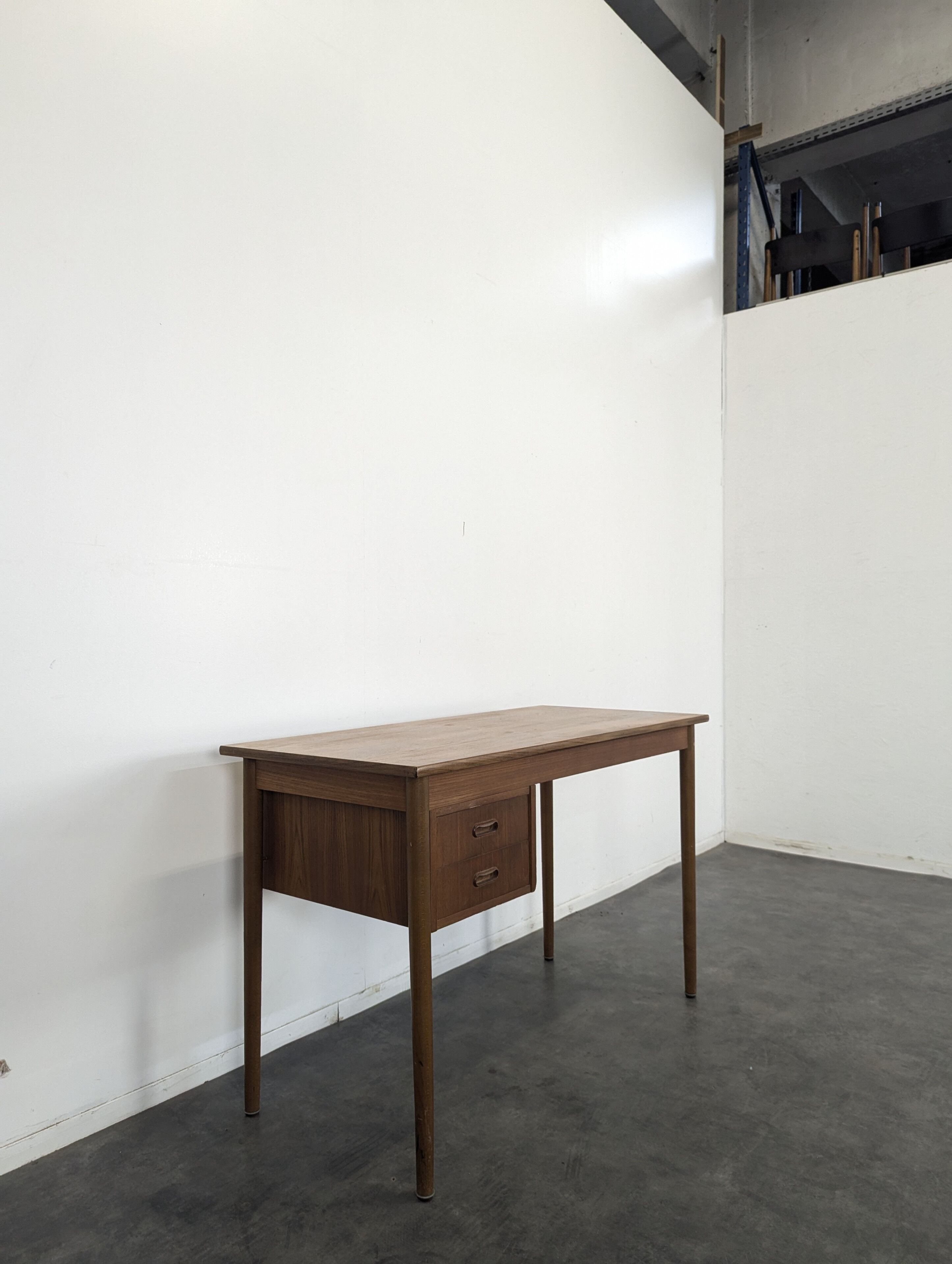 Scandinavian teak desk with a suspended drawer unit.
