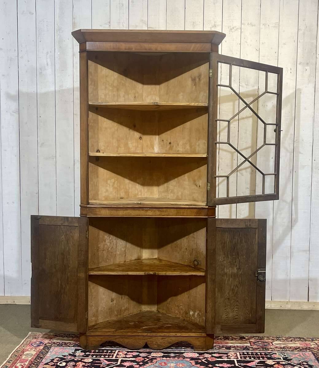 19th-century English corner cabinet in oak, mahogany, and fir.