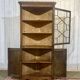 19th-century English corner cabinet in oak, mahogany, and fir.