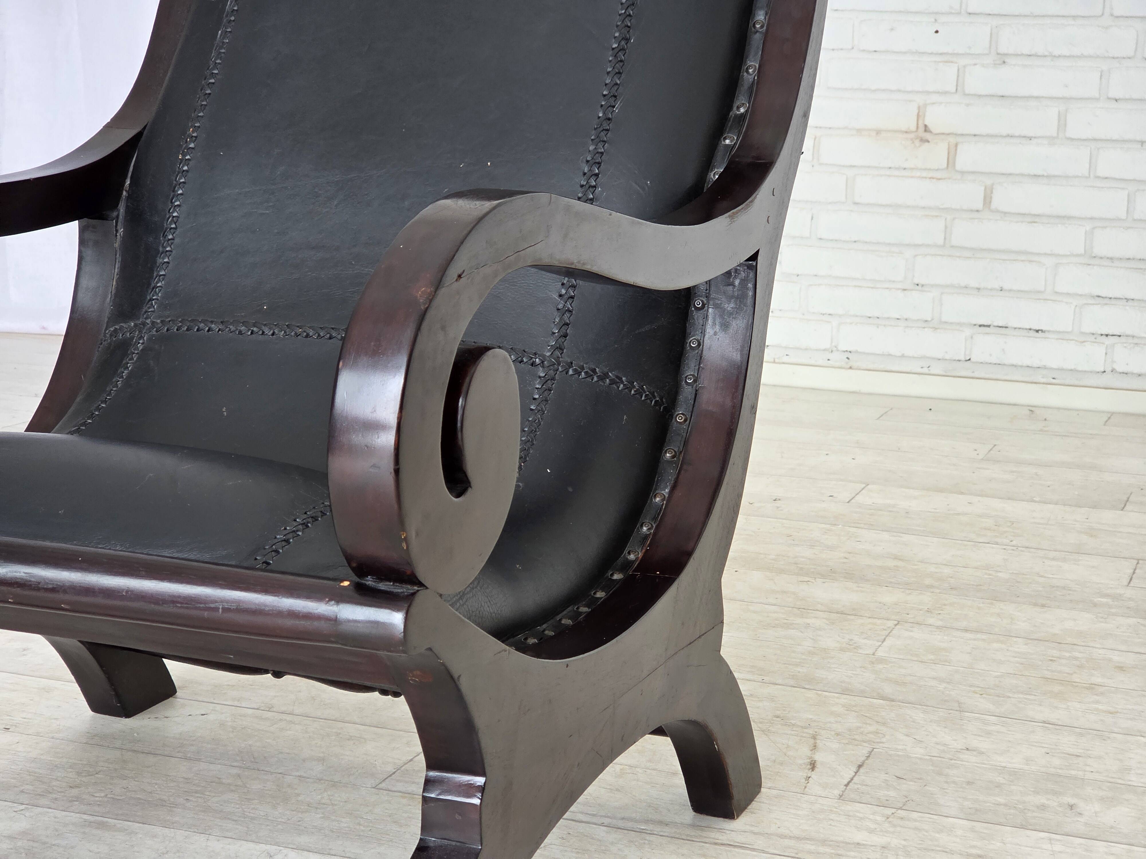 1970s, vintage armchair with footstool, black furniture leather.