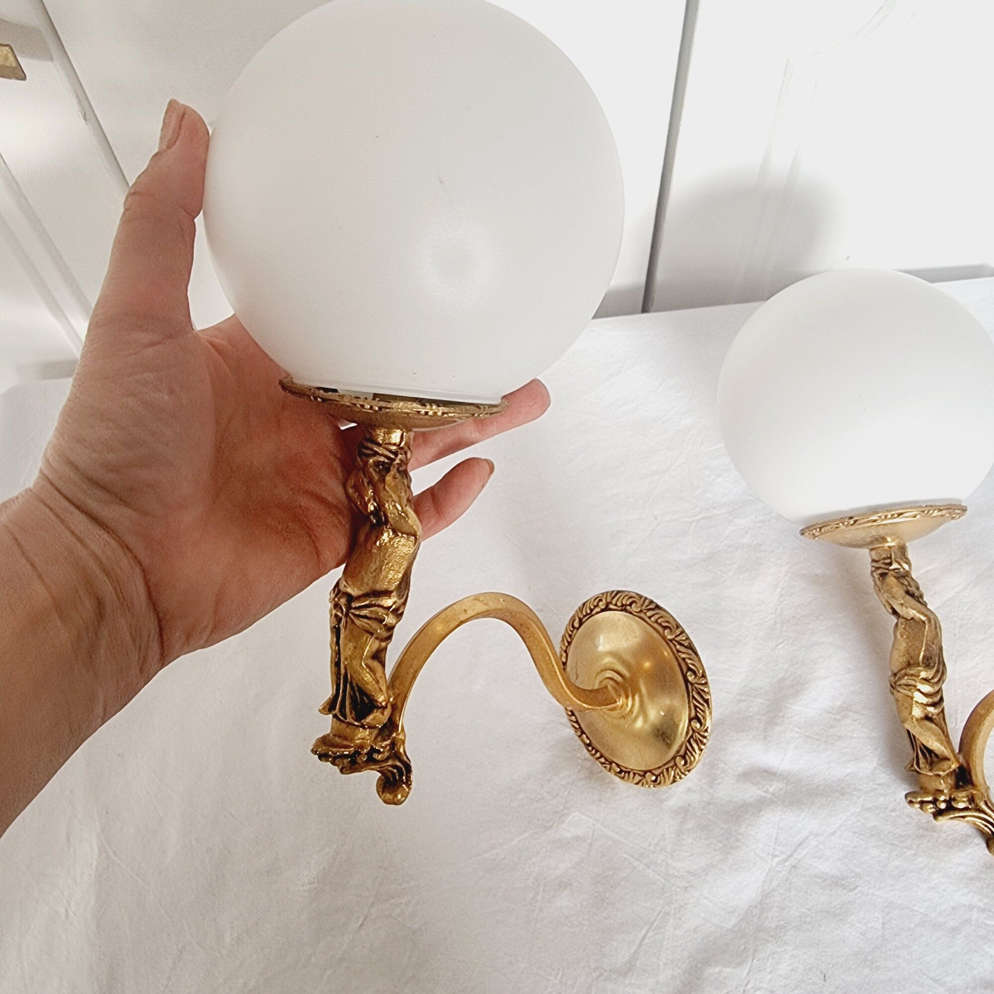 2 classic golden cherub wall lights and globe lampshades in perfect condition.