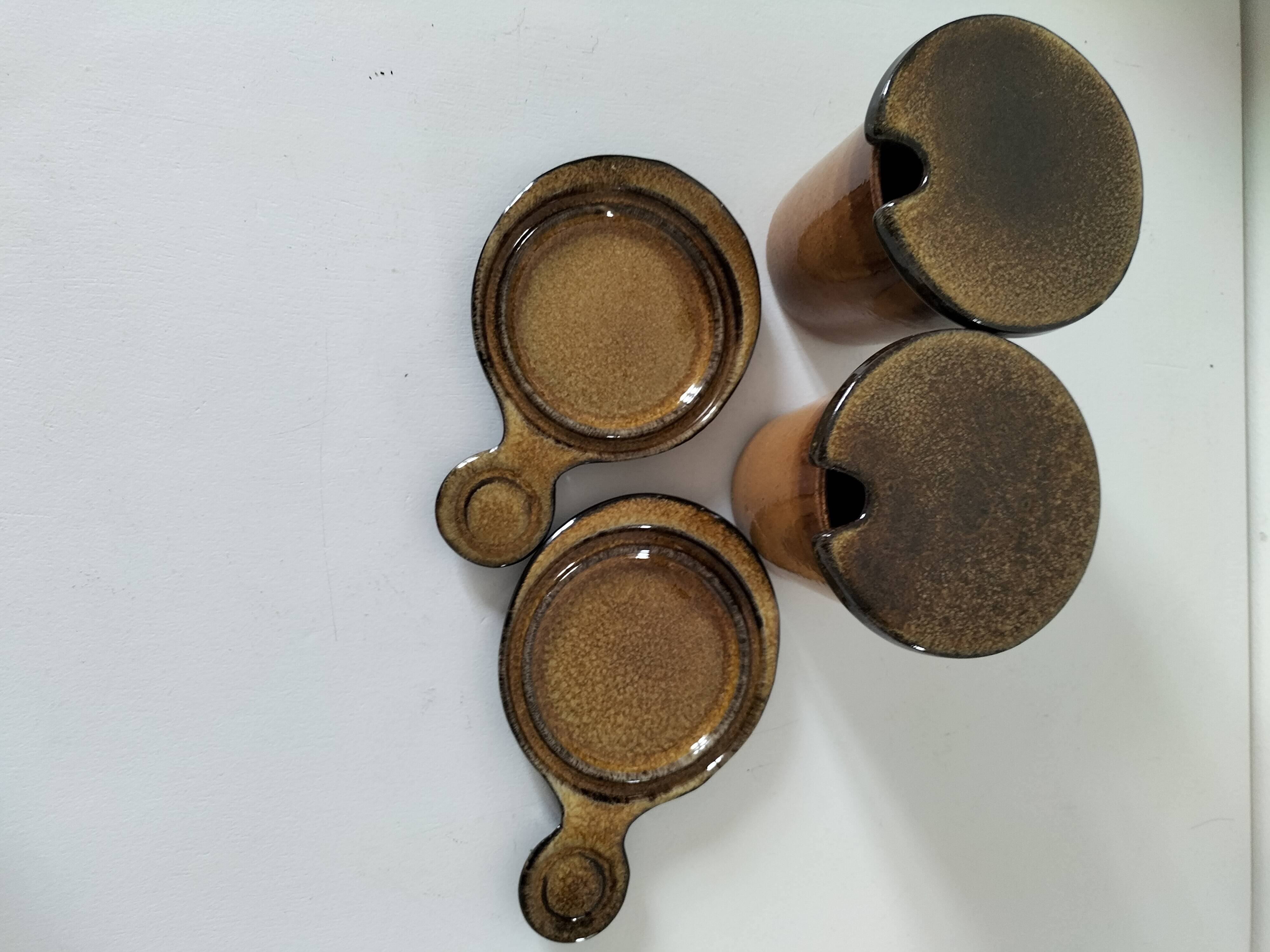 Pair of glazed stoneware cups with saucers and lids