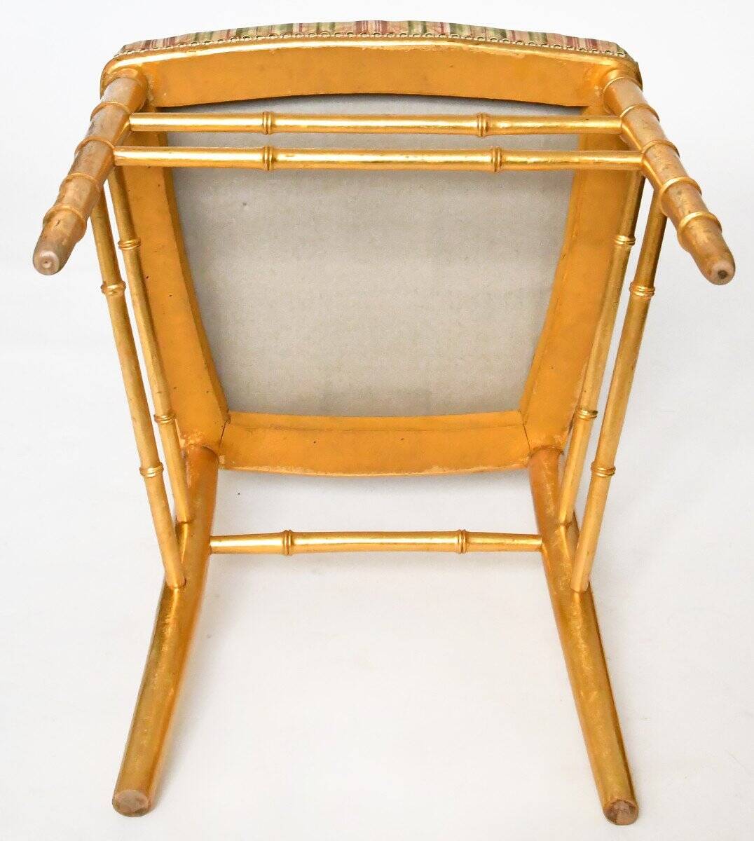 Pair of golden wood chairs in a bamboo style.