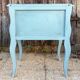 Pair of patinated lagoon blue bedside tables, early 20th century, with curved legs.