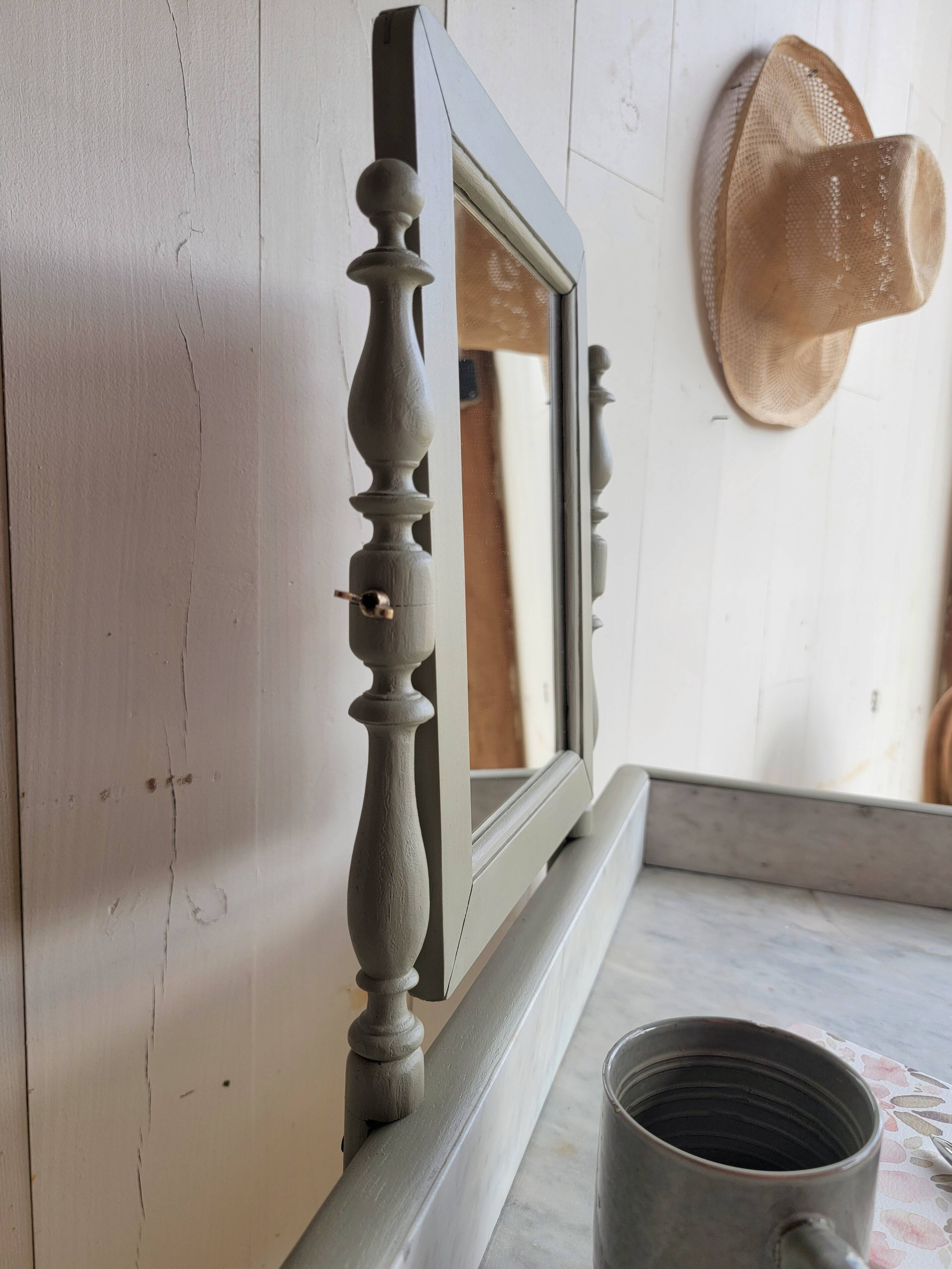 Antique wooden dressing table with marble top and mirror.