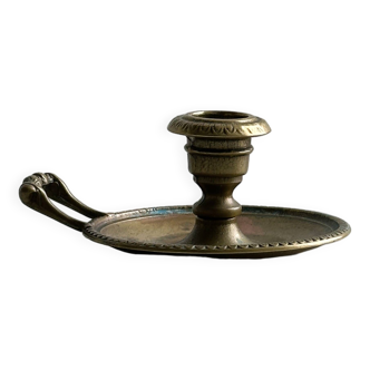 Brass candle holder with handle.