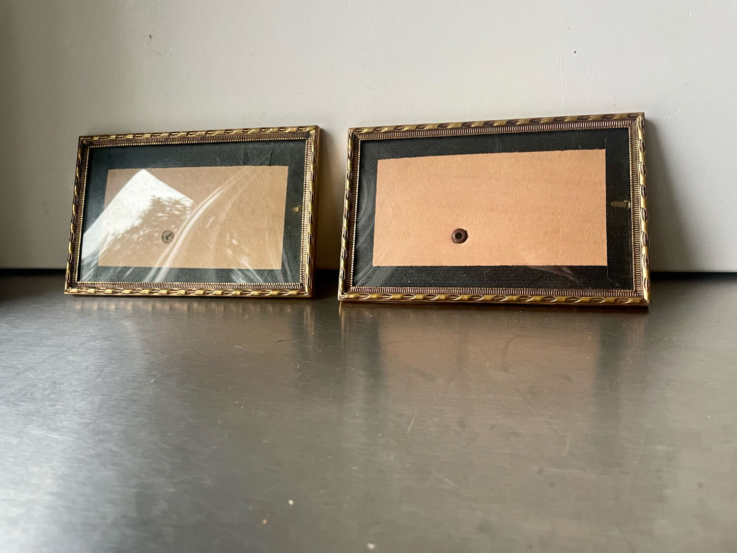 Pair of identical gold colored metal frames each measures  14.5 cm x 9 cm convex glass