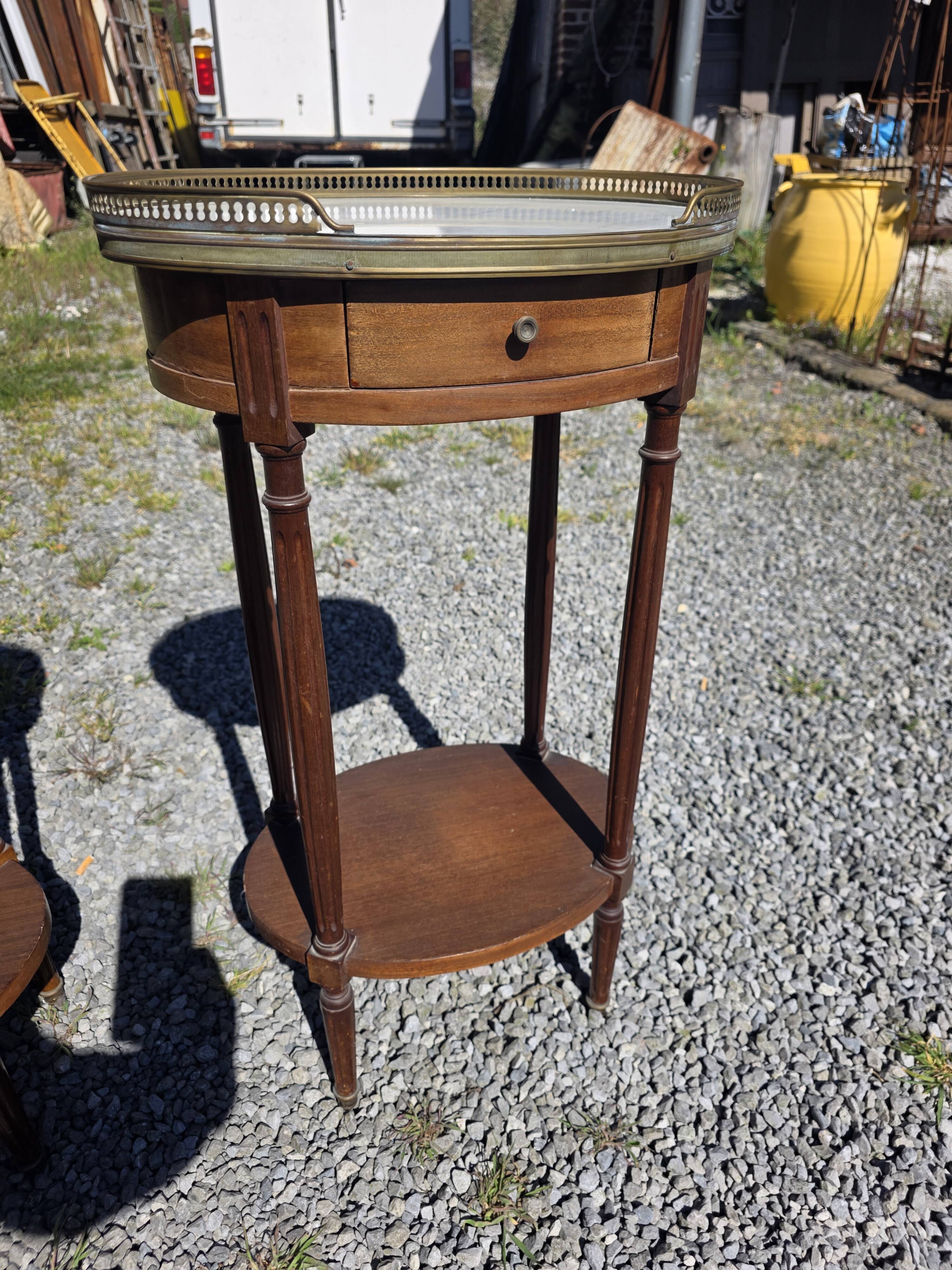 Pair of Louis XVI style bedside tables in mahogany, with marble tops.