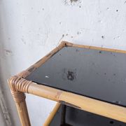 Rattan bookshelf and black glasses