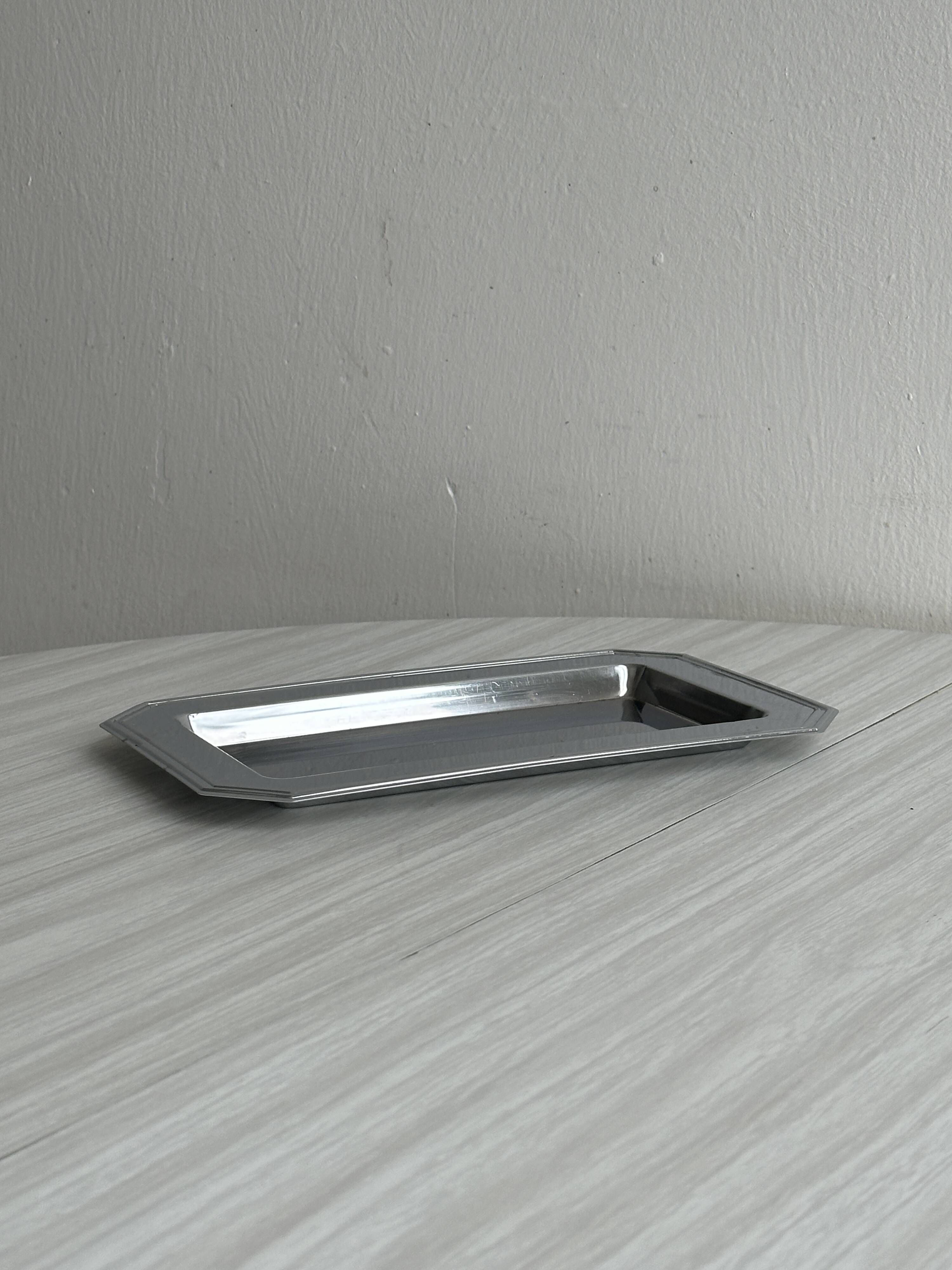 Small rectangular tray made of lightweight metal.