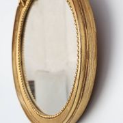 Oval giltwood mirror with rococo-style floral crest, mid-20th century