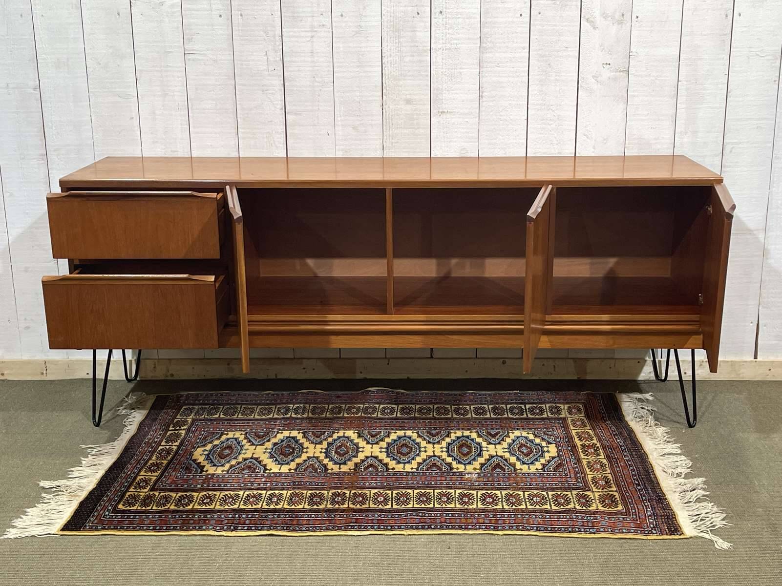 1970s English enfilade in teak with splayed legs.