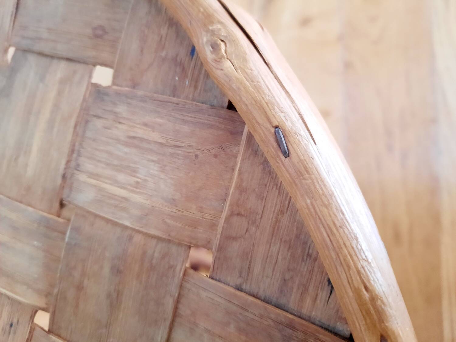 Old bamboo/rattan table with woven palm leaves.