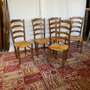 Set of 5 antique solid oak chairs with straw seats.