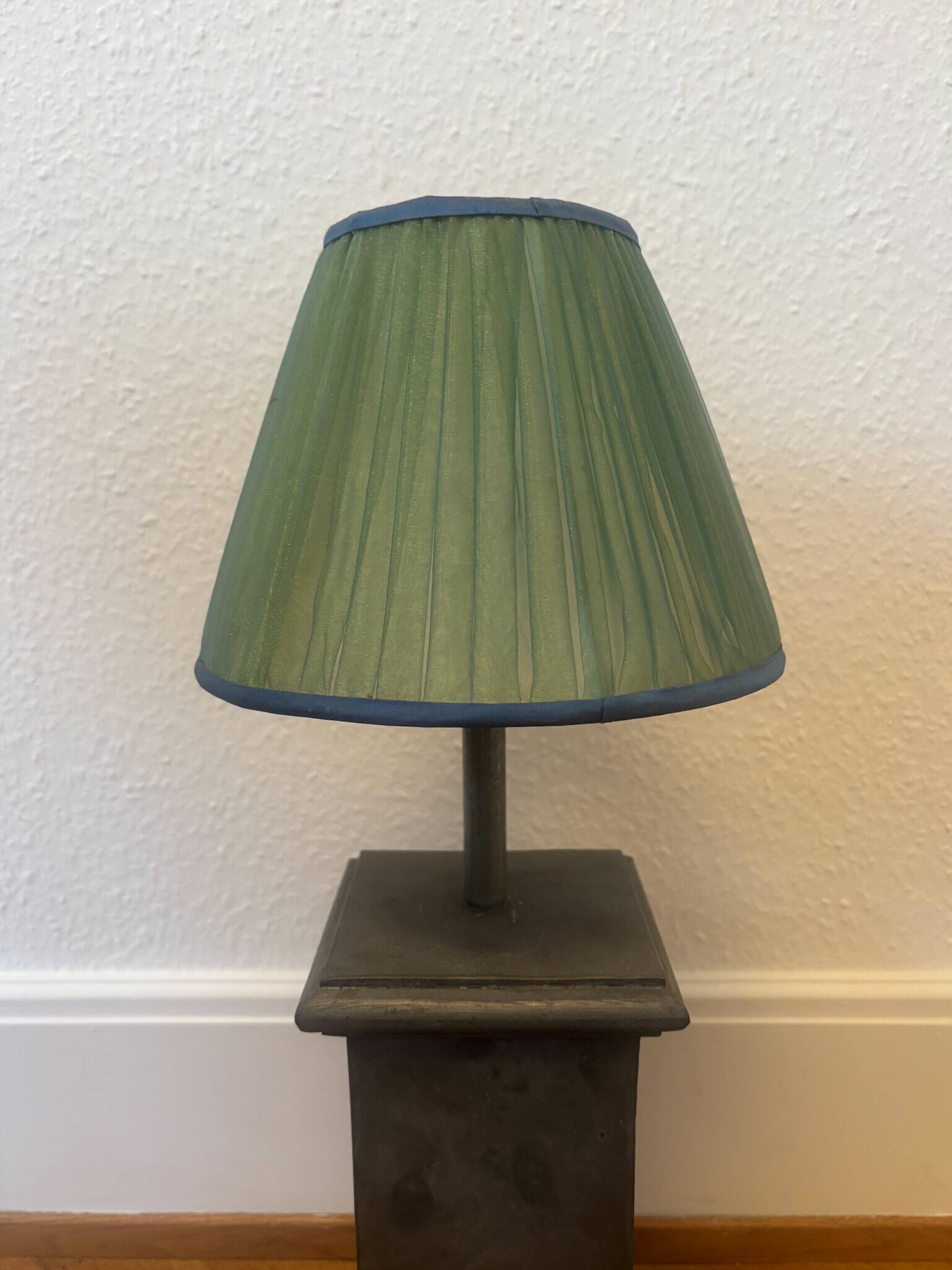 Vintage stone lamp with green pleated shade.