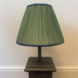 Vintage stone lamp with green pleated shade.