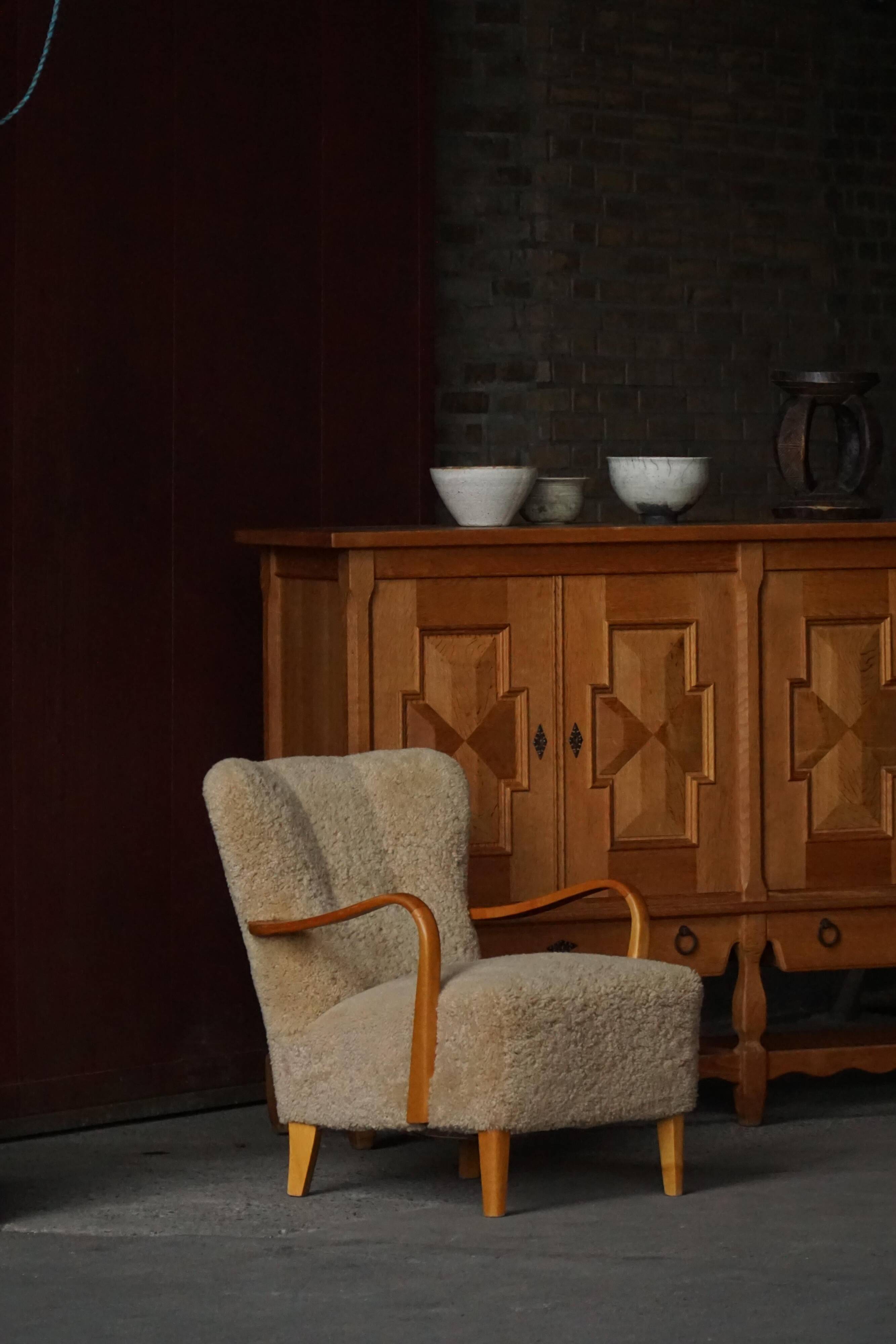 Pair of Mid Century Modern Swedish lounge chairs in birch and lamb's wool, 1960s.