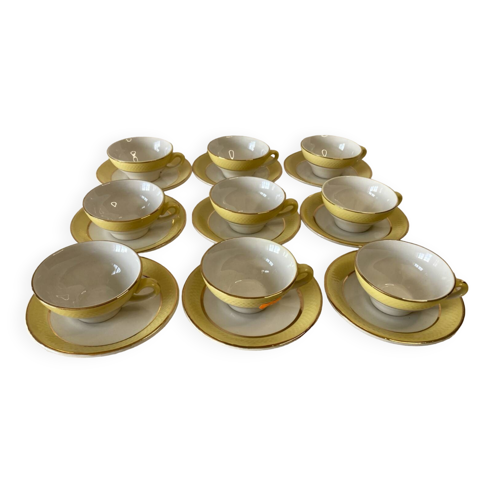 Yellow and white cups and saucers with gold trim Moulin des loups
