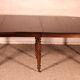 Extensible dining table from the early 19th century in walnut.