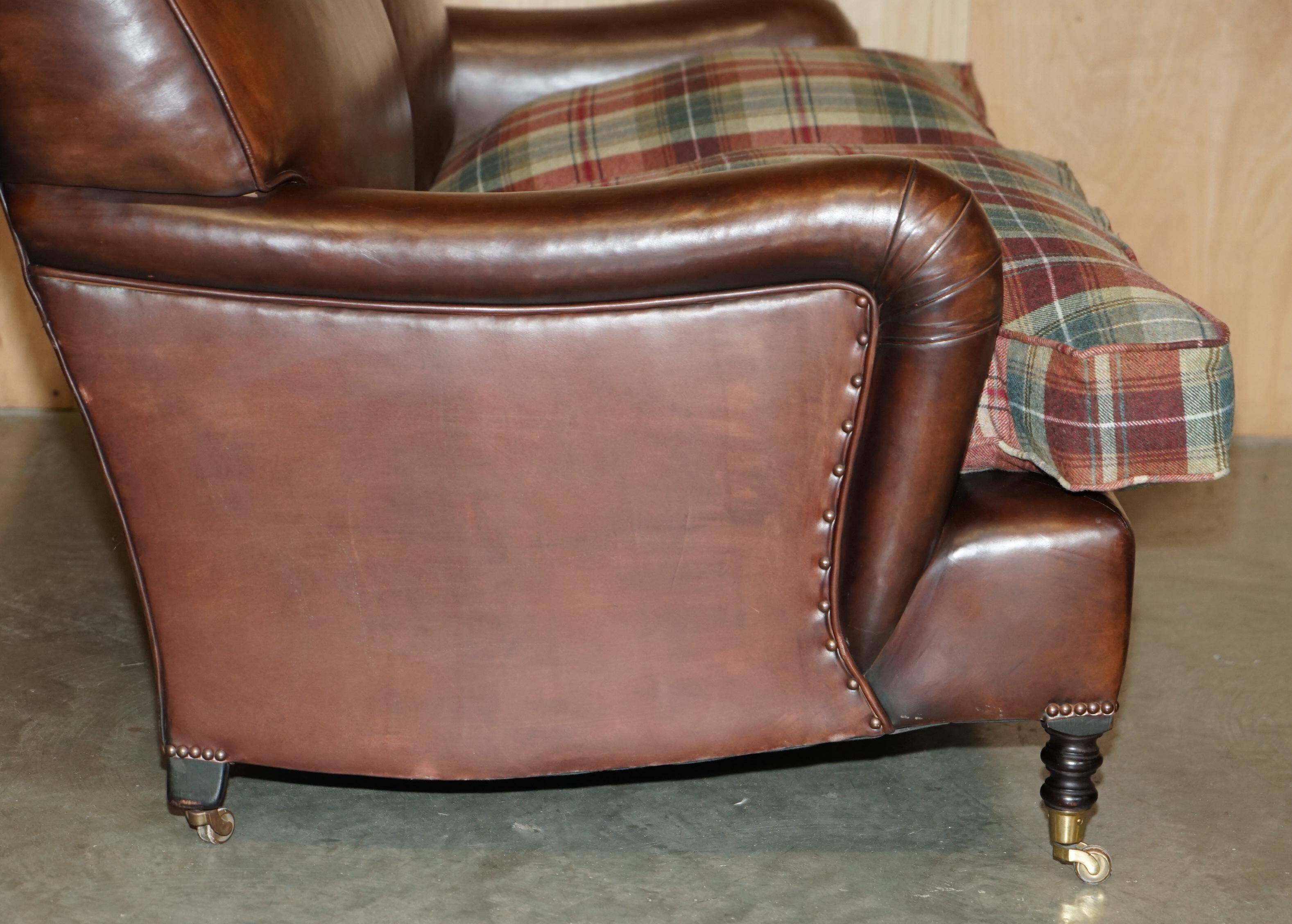 George Smith Signature Scroll leather canapé with tartan Scottish wool cushions.