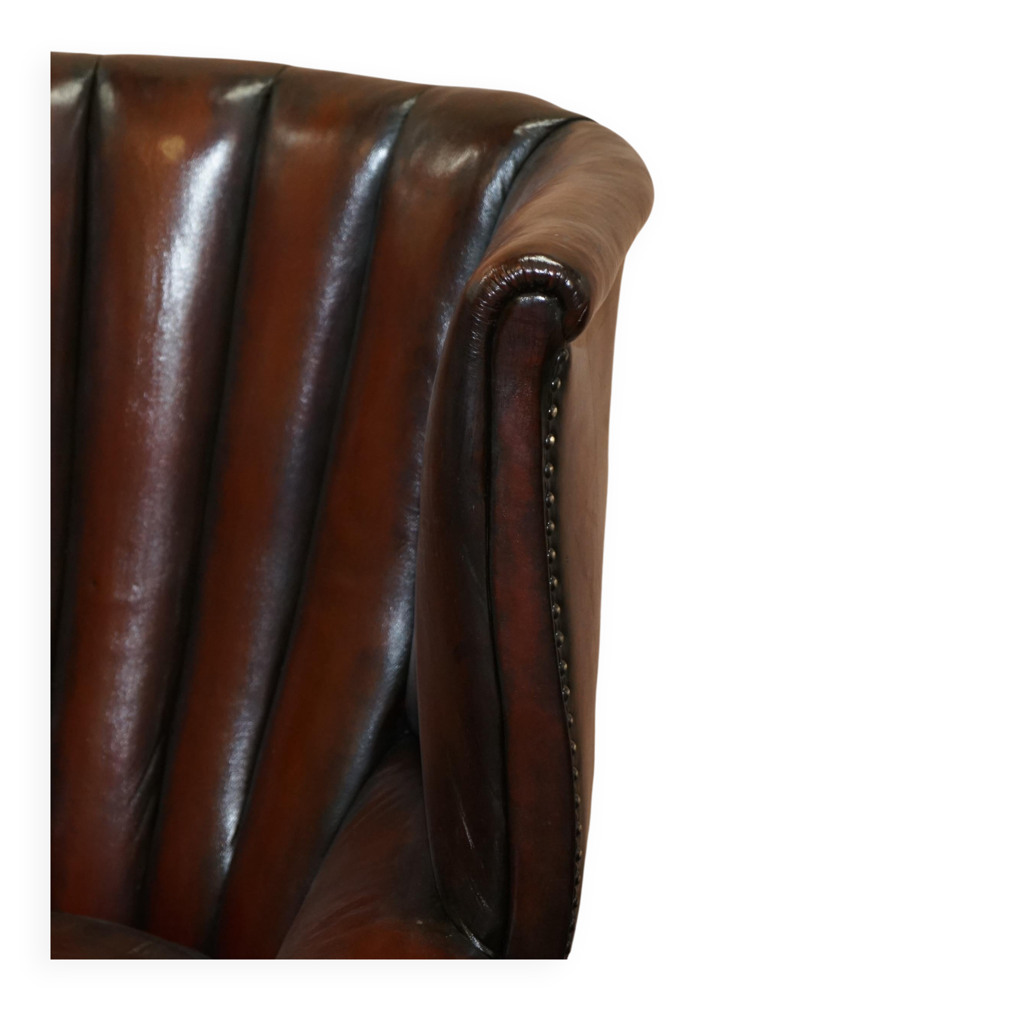 Victorian leather canapé and armchair, barrel back, circa 1860, restored.