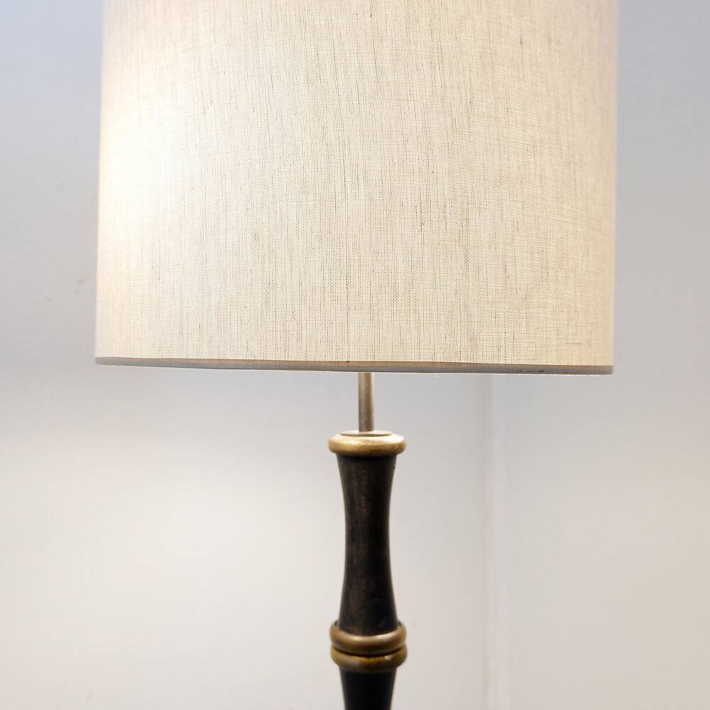 Tripod floor lamp in wrought iron and brass with bamboo-style base.