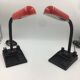 Duo of red and black flexible desk lamps with pencil holder