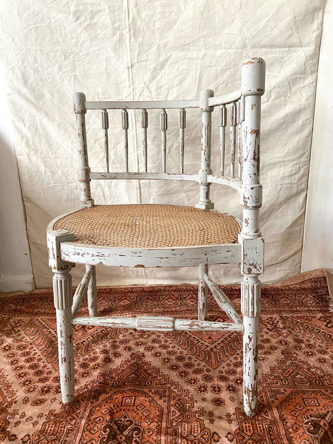 19th-century corner fireplace armchair, wood and cane.